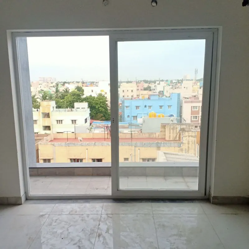 White sliding door opening onto a rooftop terrace