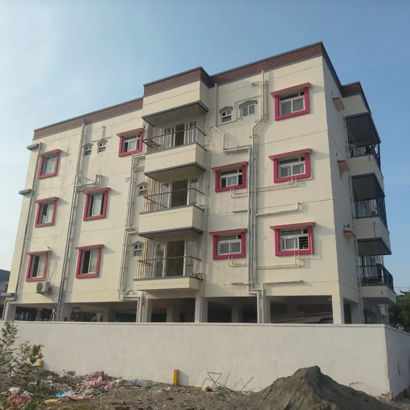 Apartment exterior with white windows and pink surrounds