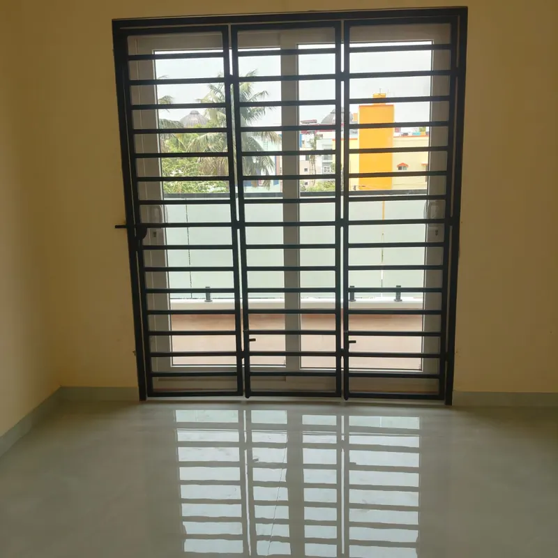 Black security grille over a white sliding door